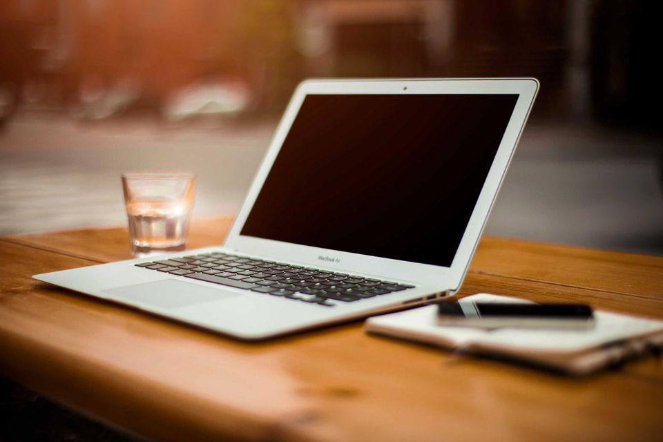 Laptop and notebook on oak