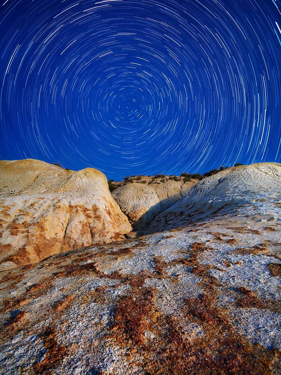Star trails above lichen rock